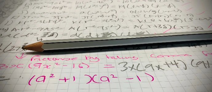 A pencil sitting on top of a piece of paper